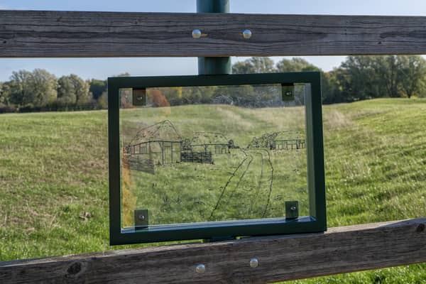 Viewing panel shows the outline of a medieval village, helping visitors see the hidden history
