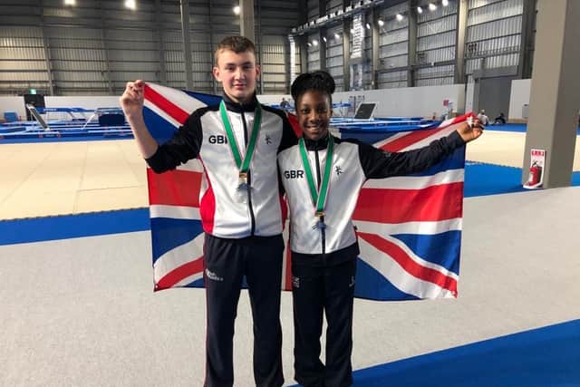 Jake and Naana celebrate their medals
