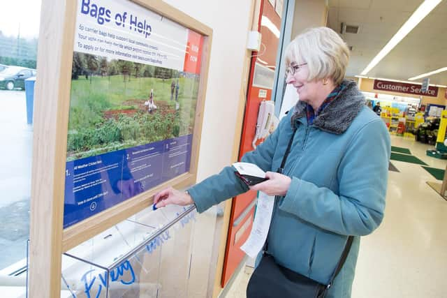 A shopper casts her vote