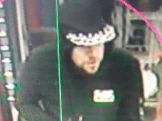 CCTV image of a man officers would like to speak to following a robbery in Wolverton