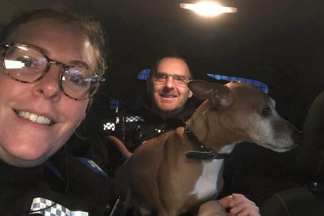 Police took the shivering dog into their warm car