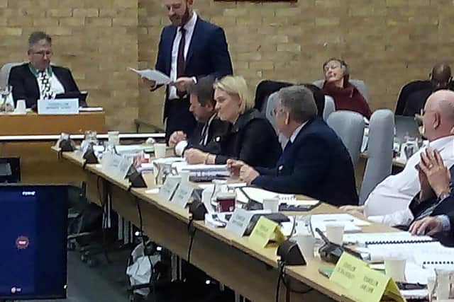 Conservative leader Alex Walker, standing