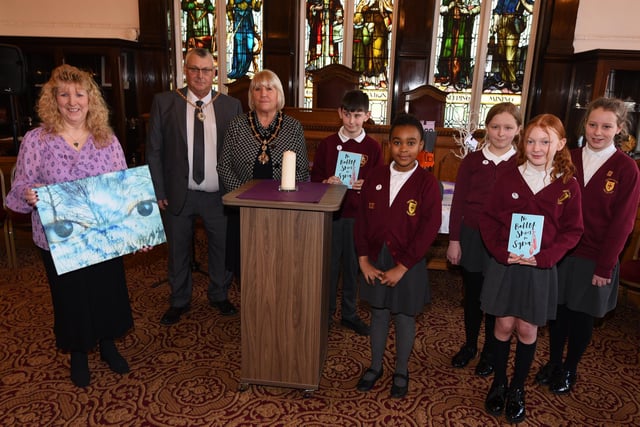 The commemoration event held at Leigh Town Hall. Event organiser Jean Hensey-Reynard, left, Deputy Mayor of Wigan Coun Marie Morgan and consort Clive Morgan with pupils from Sacred Heart RC Primary School, Leigh.