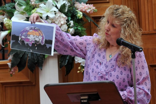 Event organiser Jean Hensey-Reynard with one of three photographs by students from the Wigan borough, chosen to show in a national gallery for Holocaust Memorial Day 2022, pictured at the ceremony at Wigan Town Hall.