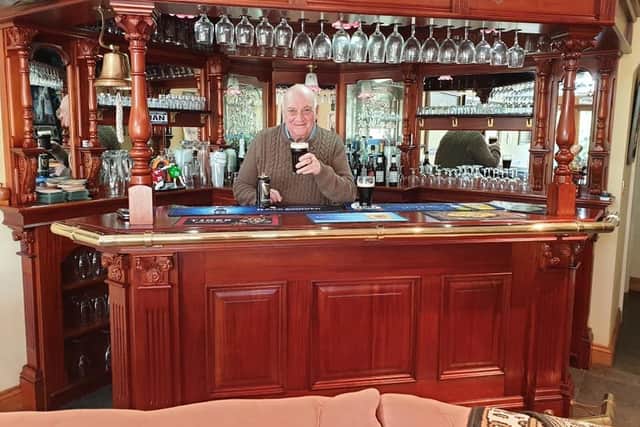 Ian enjoys a pint in his home bar