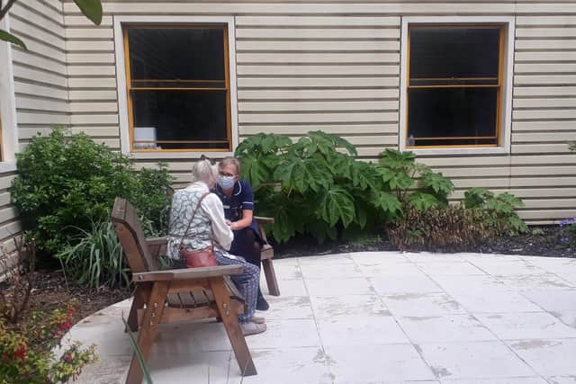 Tracy Davis, Senior Sister on Ward 3, with a patient in the courtyard garden