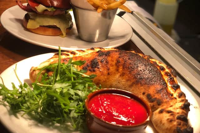 Delicious Calzone Nduja fresh from the wood-fired oven and a burger with fries shows there is something for everyone on the Oakman's menu