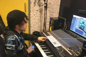 A student tries out the music studio