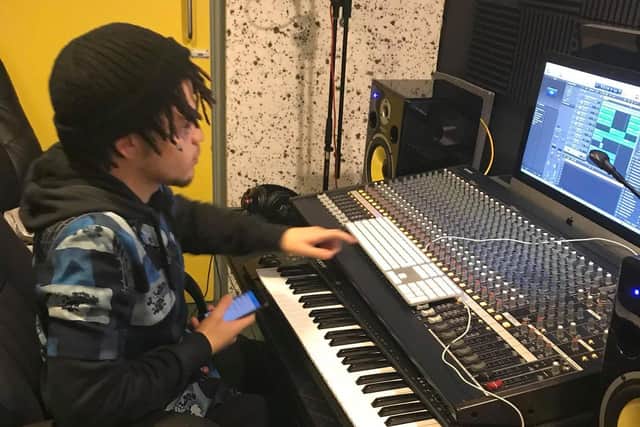 A student tries out the music studio