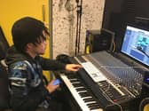 A student tries out the music studio
