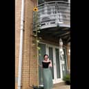 Emma next to her towering sunflower