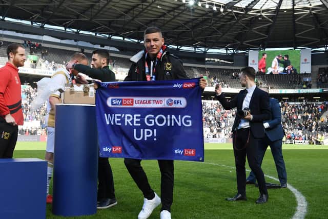 Walker celebrating promotion with Dons in 2019