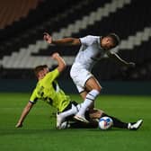 Carlton Morris rides a challenge against Northampton