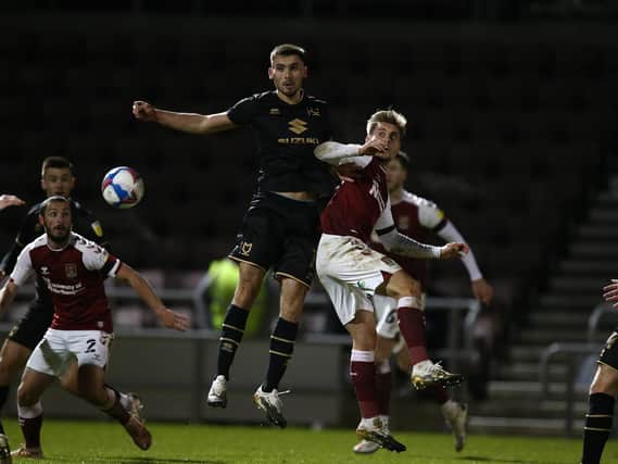 Warren O'Hora battles in the air against Northampton