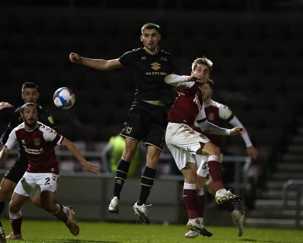 Warren O'Hora battles in the air against Northampton