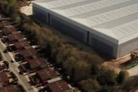 The warehouse looms over nearby residents' homes