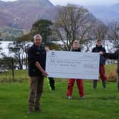 The cheque was presented to the colleagues by the company's chief executive