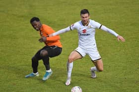 Daniel Harvie battles for the ball against Barnet