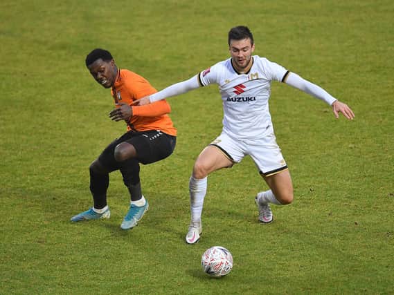 Daniel Harvie battles for the ball against Barnet
