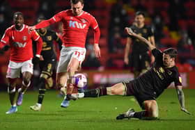 Ben Gladwin tackles former Dons team-mate Alex Gilbey at Charlton on Wednesday