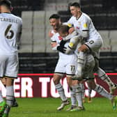 Ste Walker and John Freeman celebrate Lasse Sorensen's first career goal with him.