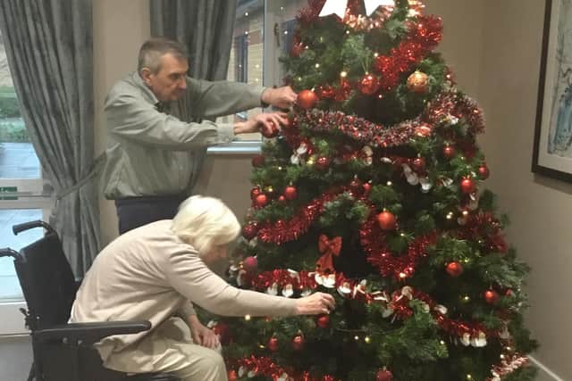 David and Glennis decorate their Christmas tree together