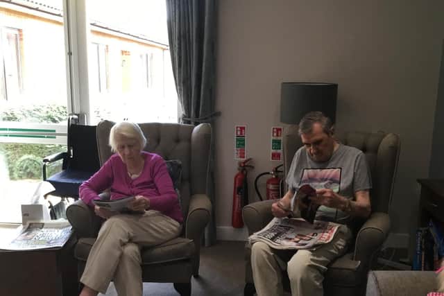 The couple enjoy quiet time reading the papers together