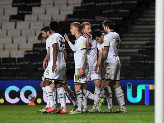 Dons celebrate after scoring against Bristol Rovers