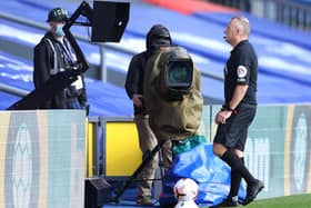 Referee Jonathan Moss checks an incident on the monitors