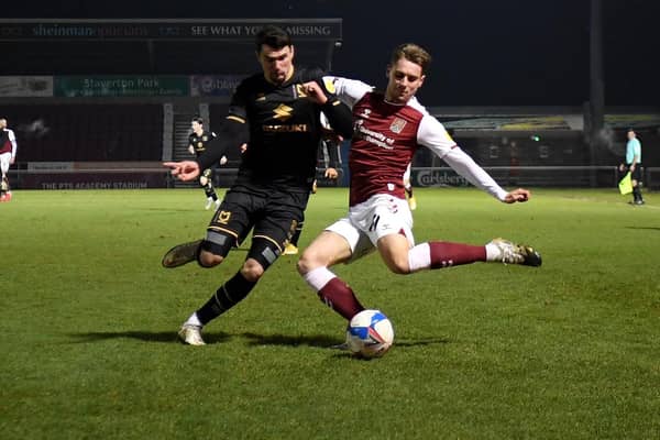 Regan Poole battles at the back against Northampton Town