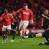 Ben Gladwin tackles former Dons midfielder Alex Gilbey