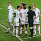 Dons protest with the referee during their defeat to Charlton