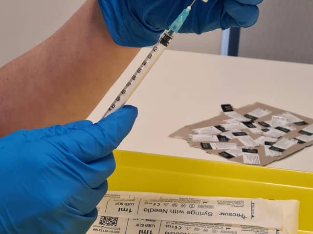 A Covid vaccine is carefully prepared. The timing is crucial