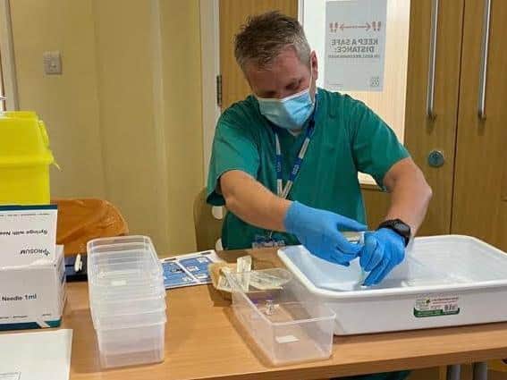 A medic prepares the precious jabs at a vaccination centre