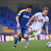 Dean Lewington throws himself into a tackle