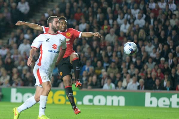 Will Grigg scores with his chest against Manchester United