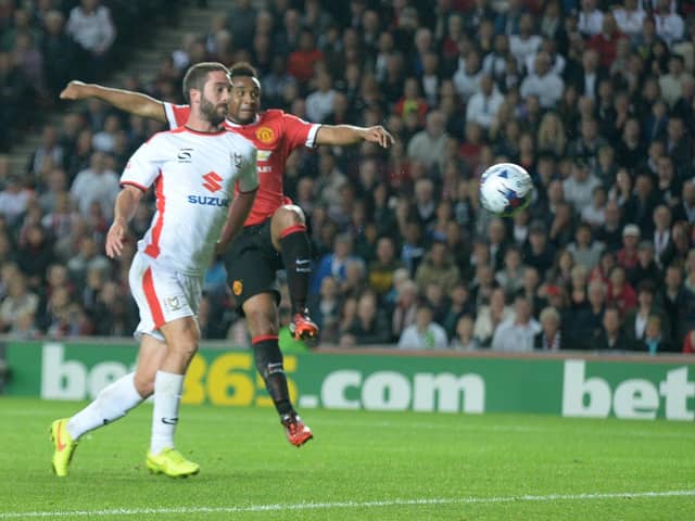 Will Grigg scores with his chest against Manchester United