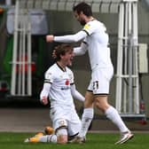 Charlie Brown celebrates his first Dons goal