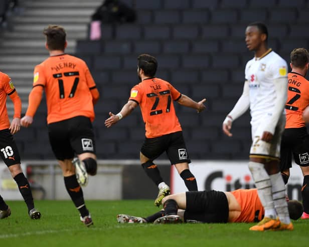 Oxford's Elliot Lee celebrates his late equaliser against Dons