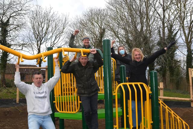 Childminder Sam Simmons tries out the new play equipment with fellow campaigners