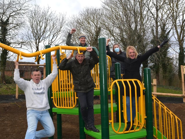 Childminder Sam Simmons tries out the new play equipment with fellow campaigners