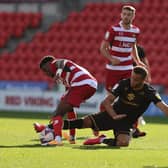 Carlton Morris goes in for a challenge against Doncaster Rovers