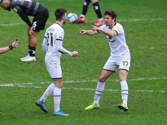 Matt O'Riley celebrates with Daniel Harvie after the Scot's winner against Doncaster
