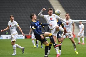 Alex Gilbey battles for the ball against Doncaster Rovers