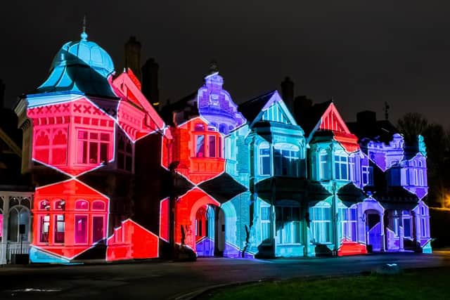 The mansion as lit up with maths and Islamic Art symbols and colours