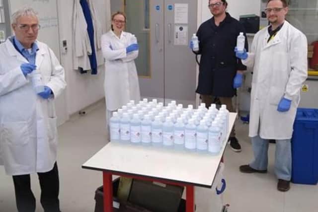 The scientists with their mega batch of hand sanitiser