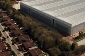 A warehouse dominates the landscape in Blakelands