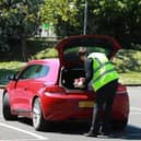 Staff put the food in the open boot of the customer's car