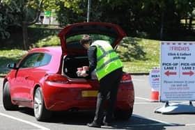 Staff put the food in the open boot of the customer's car