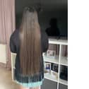 Georgina's hair is so long that she can sit on it